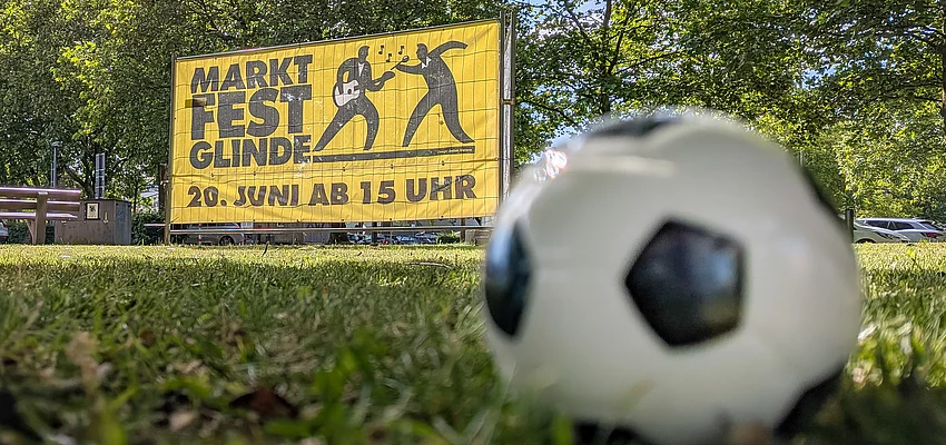 MARKTFEST Glinde & Fußball Vor einem Banner zum Marktfest Glinde liegt ein Fußball.